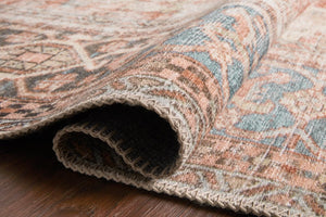 loloi terracotta sky rug edge on hardwood floor showing both color and edge finish detail.